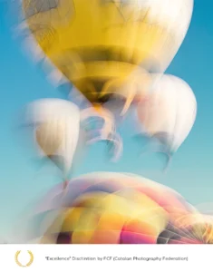 Three hot air balloons are taking off while a fourth one is being inflated. ICM photography by Jordi Roca Zanuy. Excellence distinction by FCF (Catalan Photography Federation).